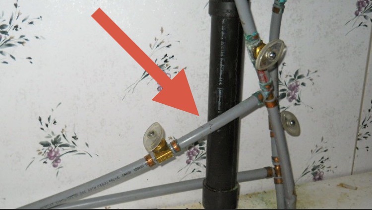 Gray polybutylene plumbing pipe under sink documented during Florida four point inspection